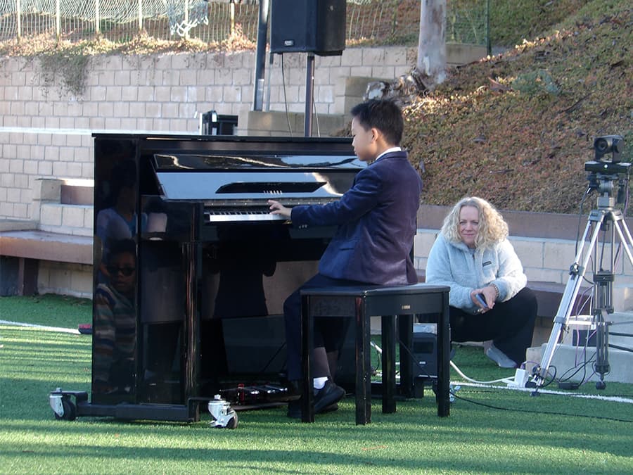 A student performing a piano piece at the Winter Talent Show