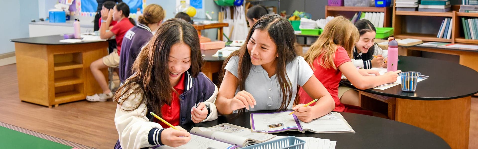 Two students working together at a classroom table
