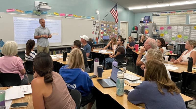 Teachers gathered for a staff training session in a classroom