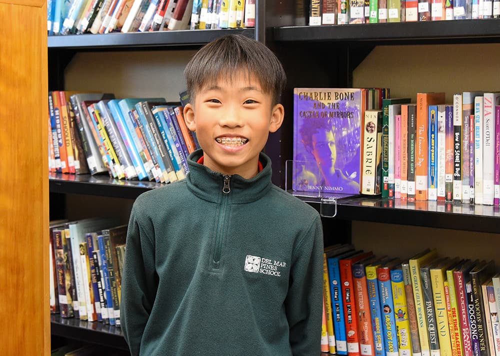 Books on a library shelf at Del Mar Pines School.